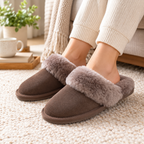 Truffle suede mule slippers with plush faux-shearling strap, worn with ribbed knit socks.
