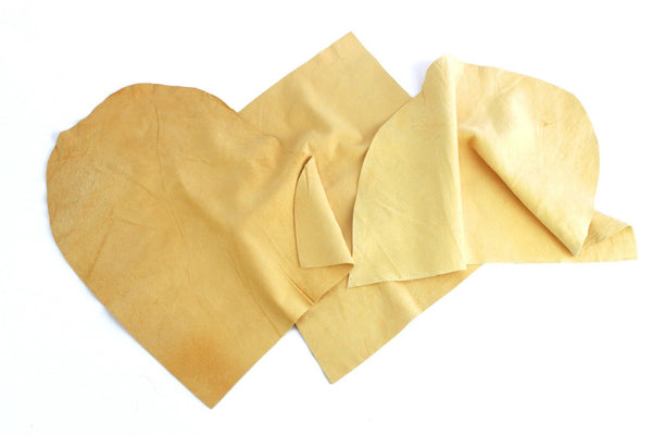 Natural chamois leather assorted cuts, stacked irregular tan pieces