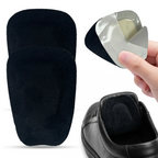 Black suede shoe tongue pads set with self-adhesive backing, one pad held by hand