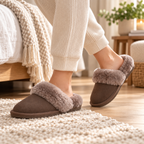 Truffle suede mule slippers, plush faux-shearling trim and textured sole seen side-on.