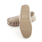 Stone suede moccasin slipper showing patterned outsole and plush interior lining